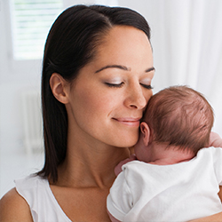 Baby with mother looking out window